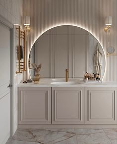 a bathroom with an oval mirror above the sink and two sinks in front of it