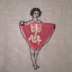 a woman with a skeleton on her back is holding a red scarf in the shape of a heart