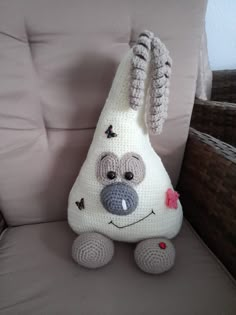 a crocheted stuffed animal sitting on top of a chair