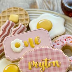 decorated cookies and waffles on a plate with the words we are peloton