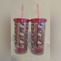 two hello kitty tumblers sitting next to each other