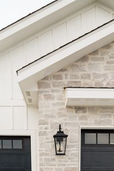 an image of a light on the side of a building that is white and black