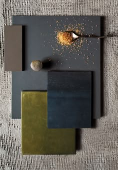 an assortment of different colors and shapes on a table with a spoon in the middle