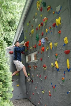 a man climbing up the side of a rock wall