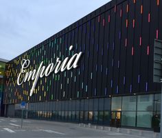 the exterior of an office building with colorful lights on it