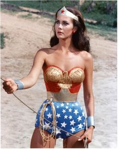 a woman in a wonder costume holding a lasso