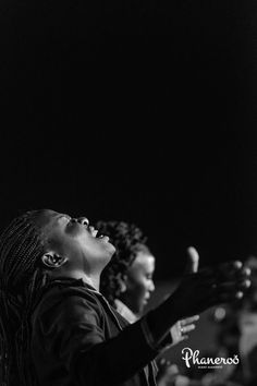 black and white photograph of two women singing