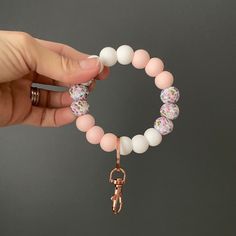 Perfect for Spring, Easter or anytime! These ultra soft floral printed beads are accented with white and baby pink silicone beads. Available keyring options are rose gold, silver, and black. This silicone bead wristlet keychain is perfect for anyone... an on-the-go mama, a busy single career woman, even a teen trying not to lose their first set of keys. Easy and convenient to carry, it rolls over your wrist, is easy to find in your bag, and can be hung up at home. The wristlet is soft, durable, Pink Wristlet Keychain, Beaded Wristlet Keychain Amanda, Mama Silicone Wristlet, Bead Wristlet Keychain, Silicone Wristlets, Silicone Bead Wristlet, Silicone Bead Wristlet 15mm, Career Woman, Soft Floral