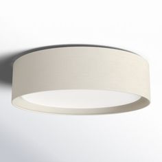 a round light fixture with a white fabric shade on the top and bottom part of it