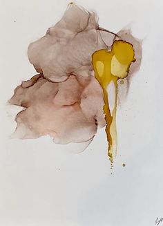 a piece of paper with yellow paint on it and some brown ink splatters