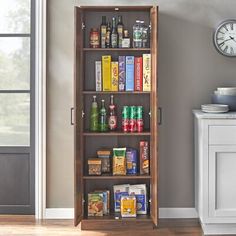 an open bookcase filled with lots of books next to a clock on the wall