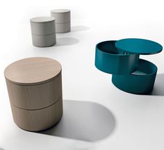 an assortment of different colored stools and tables on a white surface with shadows coming from them