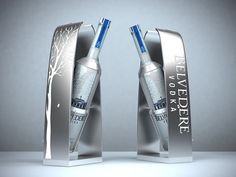 two silver bottles with blue caps are in the shape of an open bookends