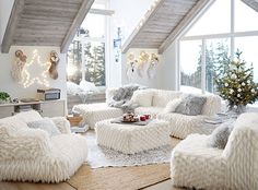 a living room filled with lots of white furniture