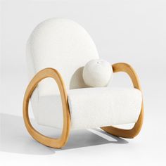 a white rocking chair with a stuffed animal on it's back and armrests