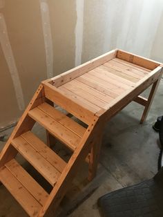 a wooden step stool sitting next to a wall