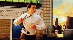 a man running in the city with his tie on