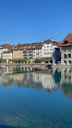 the water is clear and blue with buildings in the backgrouds on either side