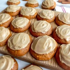 cupcakes with frosting on a wooden board