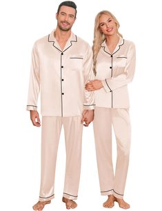 a man and woman in pajamas standing next to each other