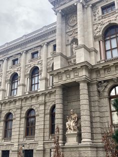 an old building with many windows and statues on the front