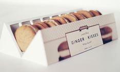 a box filled with cookies sitting on top of a white table next to each other