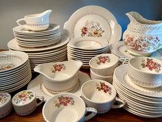 a table topped with lots of white dishes