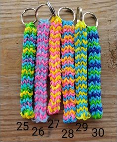 four crocheted keychains are sitting on a table