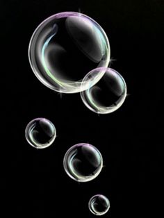 soap bubbles floating in the air on a black background