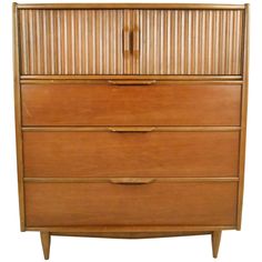 a wooden dresser with three drawers and two doors on the front, against a white background