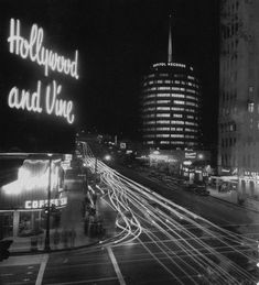 the hollywood and vine sign is lit up at night in this black and white photo