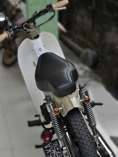 a white and black motorcycle parked on the street