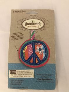 a peace sign ornament is shown on a card with the words handmade