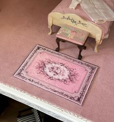 a doll house with furniture and rugs on top of the floor, including a bed