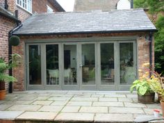 an outdoor patio with sliding glass doors and potted plants