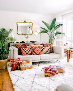 a living room filled with lots of colorful pillows