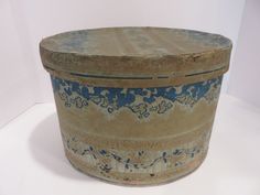 a blue and white container sitting on top of a white table next to a wall