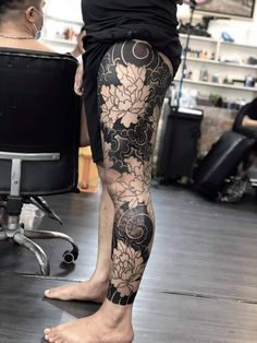 a person with tattoos on their legs