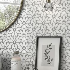 a bathroom sink with a mirror above it next to a vase and other items on the counter