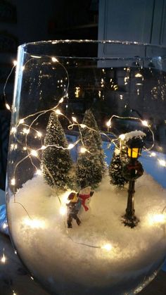 a glass filled with snow and christmas lights