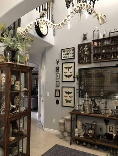 a living room filled with lots of clutter and skeleton figurines on display