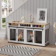 two dogs sitting in their kennels under the stairs