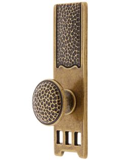 an antique brass door handle with a decorative design on the front and back side,