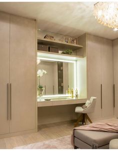 a bedroom with white furniture and a chandelier hanging from the ceiling