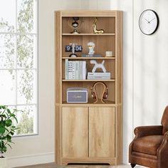 a living room with a chair, clock and bookshelf