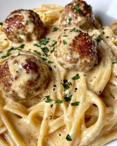 pasta with meatballs and sauce in a white bowl