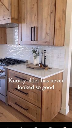 a kitchen with wooden cabinets and white counter tops, is featured in the ad for knotty alder has never looked so good