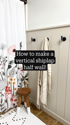 a bathroom with a white shower curtain next to a wooden stool