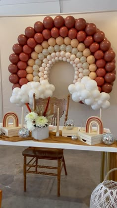 a table topped with lots of balloons and other decorations on top of it's sides