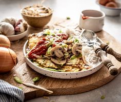 a wooden cutting board topped with rice and vegetables